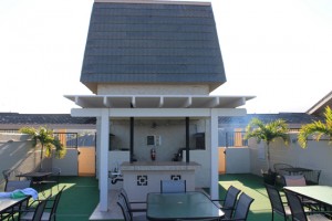 Rooftop lanai has gas grills, serving area, sinks, tables and chairs.